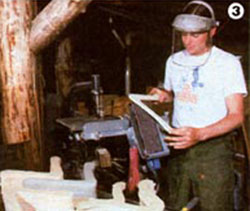 Eric smooths the surfaces of a batch of their standard-design boomerangs that they make.